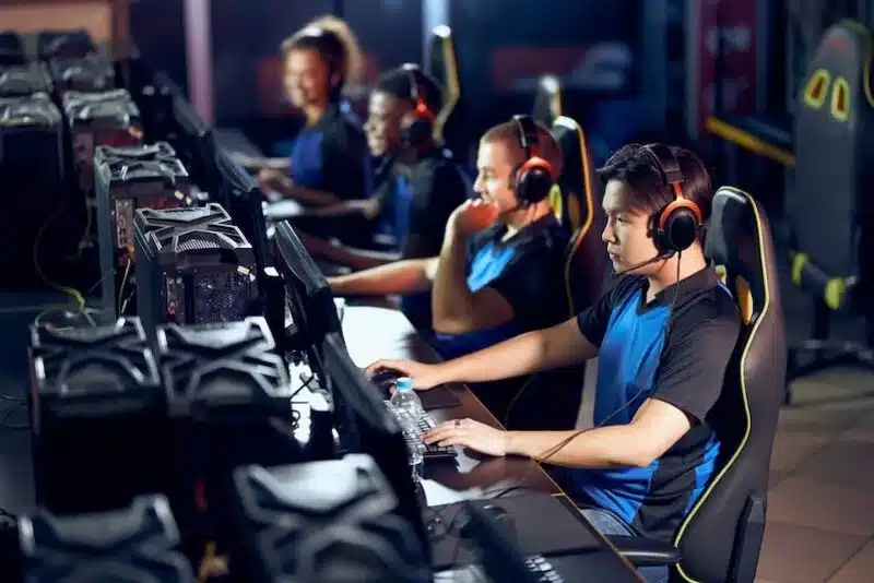 A group of gamers playing Competitive Gaming with co-players.